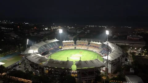 Drone shot of an illuminated cricket stadium at night in Chennai, capturing the Stock Footage 332419403