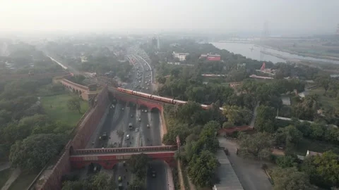 Drone shot of a Indian railways train on bridge at Red Fort New Delhi India  Stock Footage 223353289