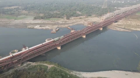 Drone shot of a Indian railways train crossing a bridge over Yamuna Delhi India Stockbeeldmateriaal 223353296
