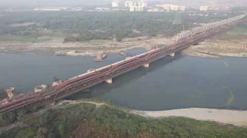 Drone shot of a Indian railways train crossing a bridge over Yamuna Delhi India Stock Footage 223353326