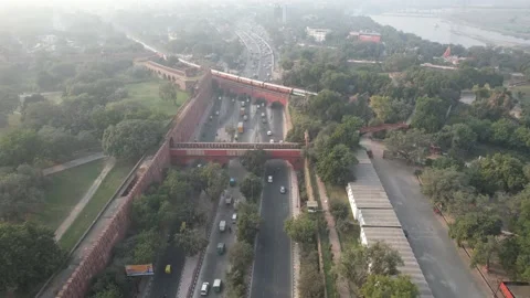 Drone shot of a Indian railways train on bridge at Red Fort New Delhi India  Video stock 223353533