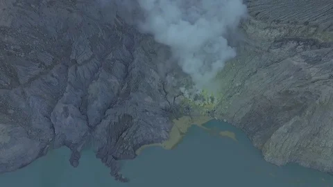 Drone shot inside of Ijen volcano framing burning sulphur. Indonesia Stock Footage 81697706