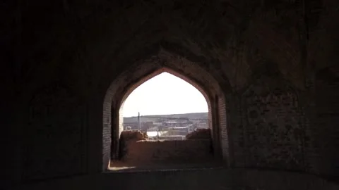 Drone shot from inside a Persian brick structure looking out through an arched Video stock 307791827