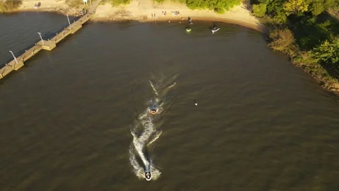 Drone shot of Jet ski taking Inflatable towable on the water, beautiful Video stock 195305834
