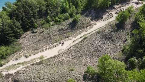 Drone shot of kids running down a sand dune at Indiana Dunes National Park. Stock Footage 260992867