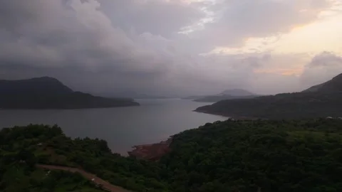 Drone shot of lake during sunset with dramatic clouds 4K25 動画素材 332893291