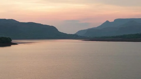 Drone shot of lake during sunset with dramatic clouds 4K60 動画素材 332893354