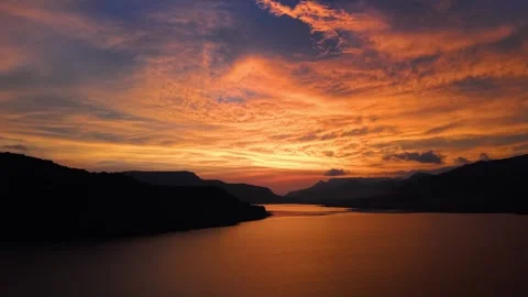 Drone shot of lake during sunset with dramatic clouds 4K60 스톡 동영상 332893389