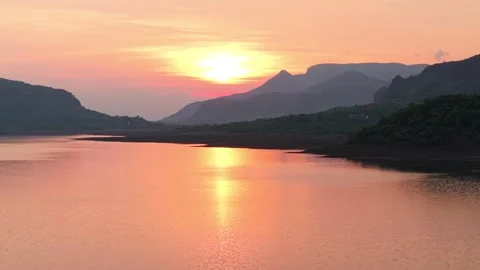 Drone shot of lake during sunset with dramatic clouds 4K60 스톡 동영상 332893394