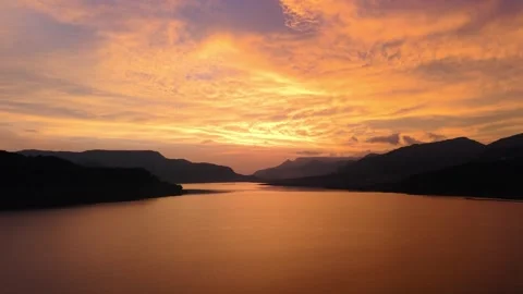 Drone shot of lake during sunset with dramatic clouds 4K60 스톡 동영상 332893399
