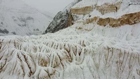 Drone shot of Lamayuru’s moon-like mountains as fresh snow transforms the arid Stock Footage 310660930