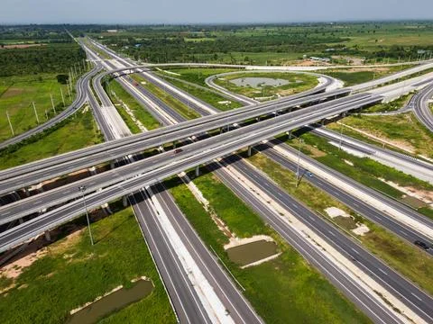 Drone shot a large highway interchange crossing over green farmlands in Tha.. Stock Illustration