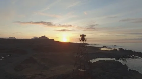 Drone shot: Lighthouse during sunset near Gjögur Airport, Iceland Stock Footage 93390885