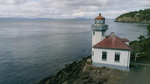 Drone shot with lighthouse looking over the sea, 4K Stock Footage 123315674