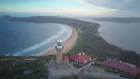 Drone shot of lighthouse on mountain overlooking a beautiful sea Stock Footage 122451910