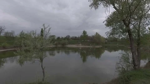Drone shot of a little lake with cloudy sky background. Stock Footage 74583728
