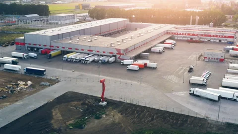 Drone Shot: Logistics Sorting Terminal with Multiple Trucks at Warehouse Loading Stock Footage 326842847