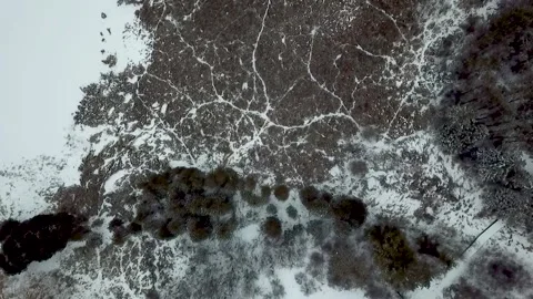 Drone shot looking down on frozen winter landscape Vídeo Stock 153860141