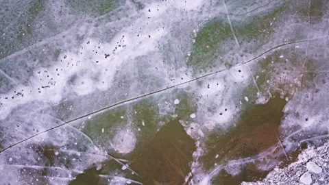 Drone shot looking down at frozen ice on the surface of St Marys River Stock Footage 336792095