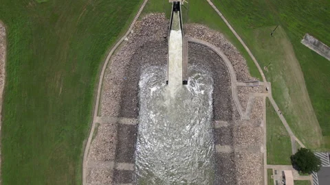 Drone shot looking down at a lakes spillway while it is open. Stock Footage 310918783