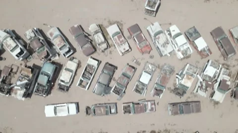 Drone shot looking down at a large desert breakers yard Stock Footage 192586791