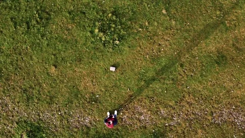 Drone shot looking down at a man flying the drone Stock Footage 260408615