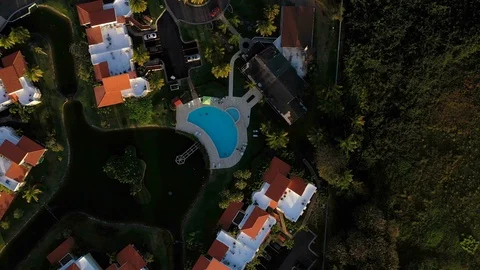 Drone shot looking down on pool resort at sunset Stock Footage 124225394