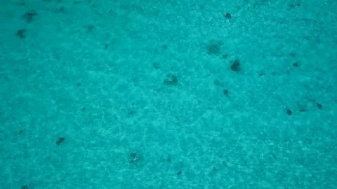 Drone shot looking down at sparkling clear tropical water Видео 107031804