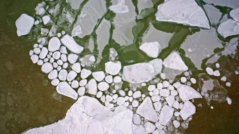 Drone shot looking down at various shapes of ice on the surface of the great Stock Footage 337721910