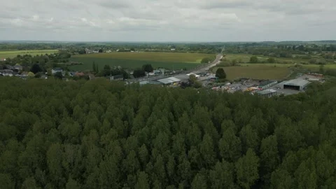A drone shot looking at empty train track revealing a train pulling into station Stock Footage 296803273