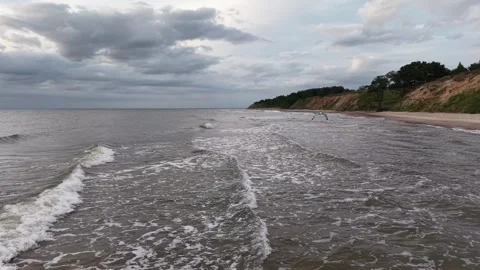 Drone shot low flying fallowing calm waves on sea shore Stock Footage 341770258