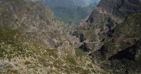 Drone shot - Low move pan down out over steep ravine Madeira mountains Stock Footage 140623274