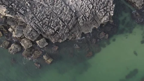 Drone shot lowering altitude towards unidentifiable fisherman with rod fishing Stock Footage 188464659