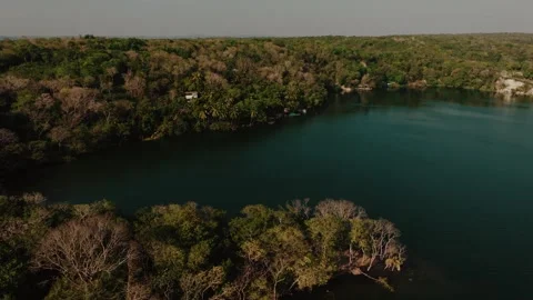 Drone Shot of Lush Forest Surrounding Lago Petén Itzá, Flores Island, Guatemala Stock Footage 340036635