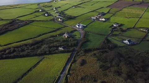 Drone Shot of Lush Green Fields, Roads and Farms in Ireland Stock Footage 89150852