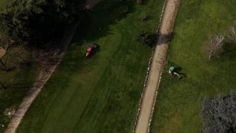 Drone shot of maintenance equipment working on a golf course, preparing smooth Stock Footage 332792709