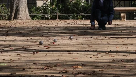 Drone shot of man playing boules (petanque) game in a park Stock Footage 288222264