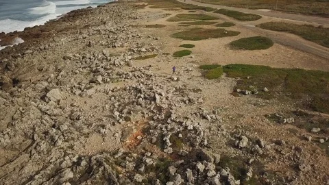 Drone shot of a man running on the ground along the seacoast in Cascais 스톡 동영상 114854635