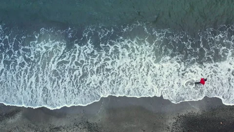 Drone Shot Of Man Walking Along Beach In Faroe Islands Stock Footage 134285831