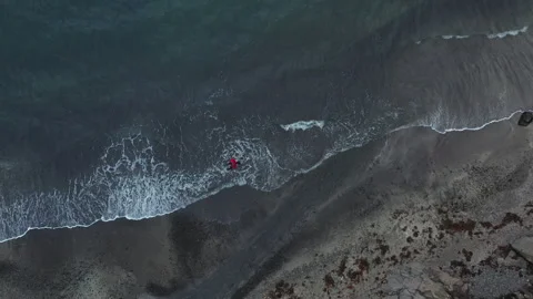 Drone Shot Of Man Walking Along Beach In Faroe Islands Stock Footage 134285867