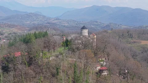 Drone Shot of Martvili Monastery Hidden Among Hilltop Trees Vídeos de archivo 340384080