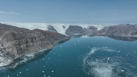 Drone shot of a massive glacier ending at the ocean in East Greenland Stock Footage 332379544