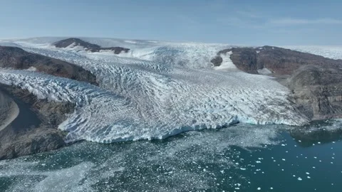 Drone shot of a massive glacier ending at the ocean in East Greenland Stock Footage 332379685