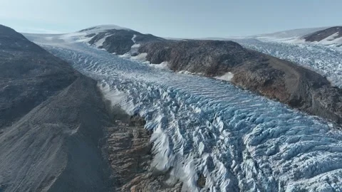 Drone shot of a massive glacier ending at the ocean in East Greenland Stock Footage 332379732