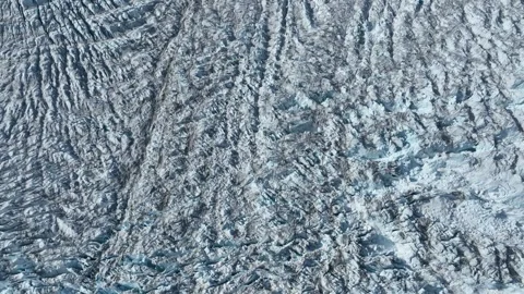 Drone shot of a massive glacier ending at the ocean in East Greenland Video stock 332379769