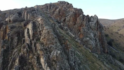 Drone shot of massive jagged rock outcrops on steep mountainside in Kazakhstan Stock Footage 337455158