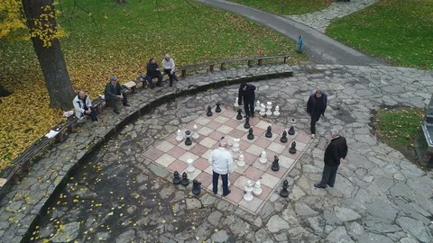 Drone shot of men playing giant chess, leisure activity Bosnia Europe Stock Footage 85449498