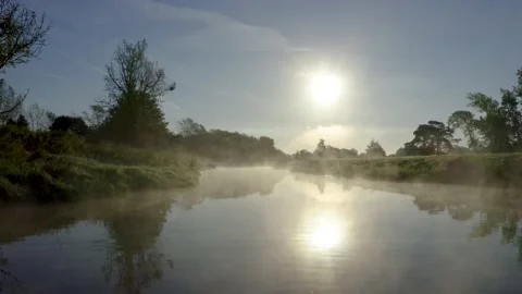 Drone shot of misty river or stream at sunrise  Stock Footage 132898273