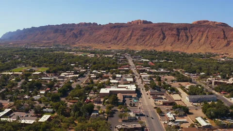 Drone shot of moab utah with red mountains behind the city Video stock 143672362