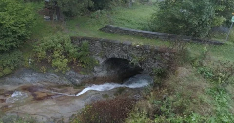 Drone Shot of montain river going under a stone bridge Stock-Footage 119211680
